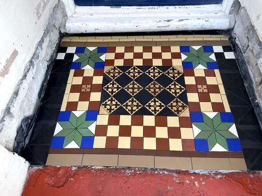 After photo of this stunning fully restored, tiled and cleaned Victorian tiled porch floor. Floor Tiling amazing colours popping showing the amazing results by Harfloor restoration Ltd
