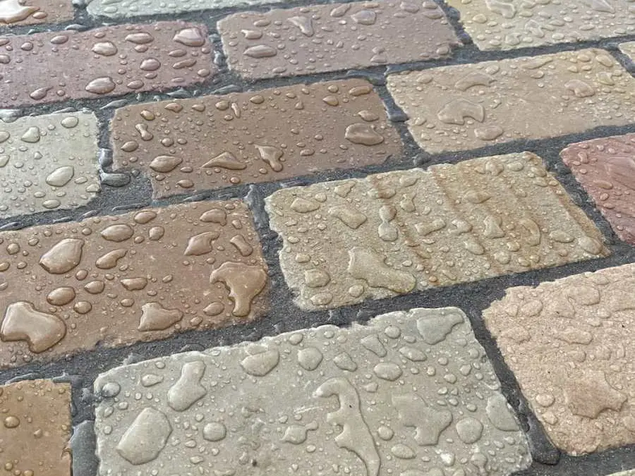 block sandstone patio beading off water because its protected by HR Colour Enhnacer patio sealer.