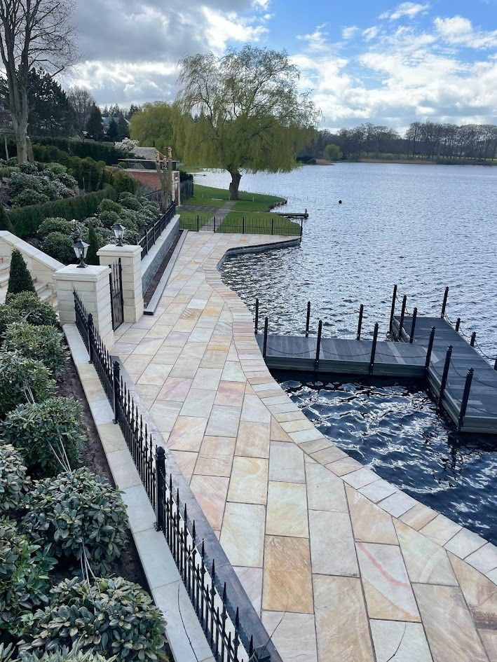 Radiant sandstone patio rejuvenated and protected by HR Stone Guard's care products, showcasing vibrant colors and textures with a durable, weather-resistant finish.