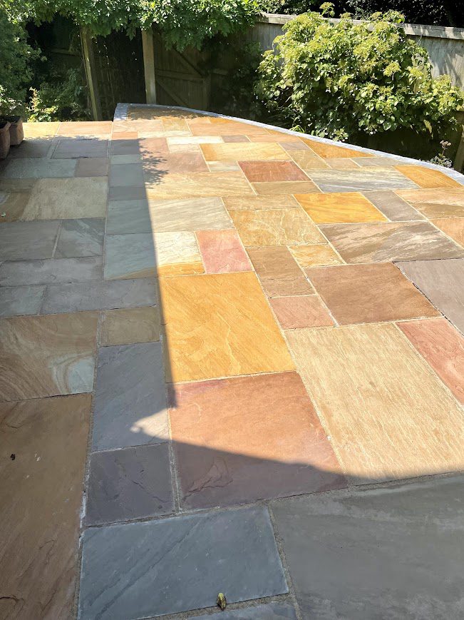 Cleaned and sealed riven sandstone patio with HR Colour Enhancer.