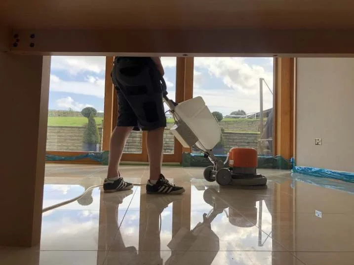 Highly polished marble floor by Hardfloor Restoration LTD with a professional floor buffer in action. Best marble polishing service Liverpool.