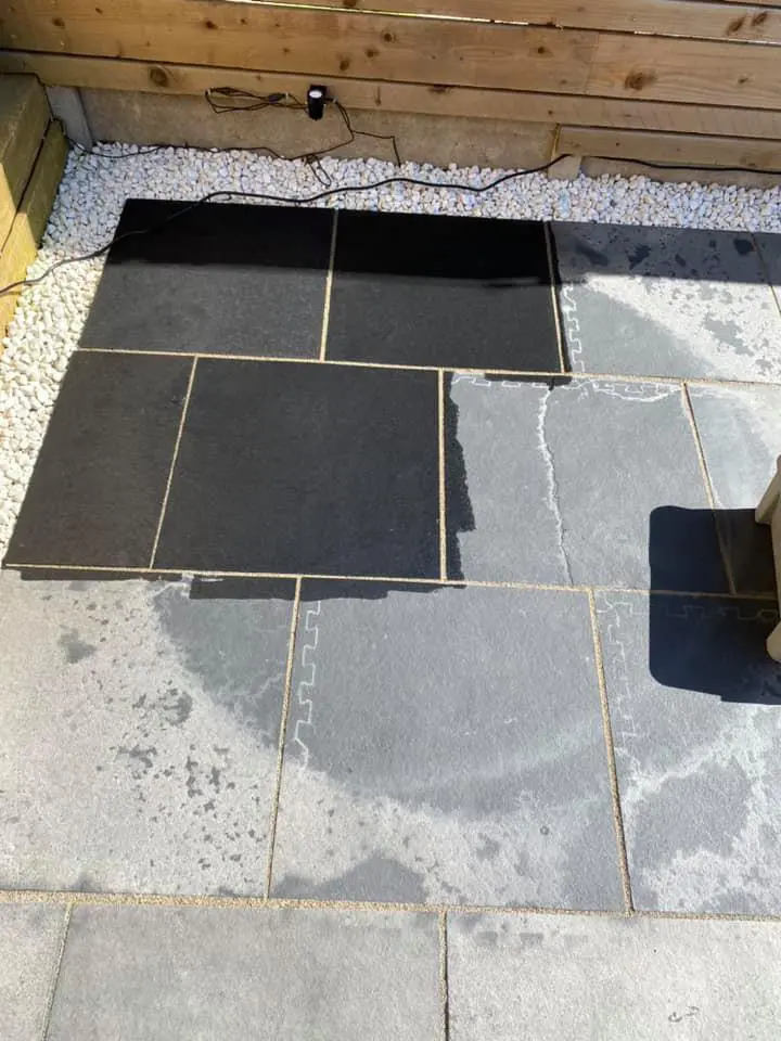 Comparison of black limestone patio half sealed with HR Colour Enhancer.