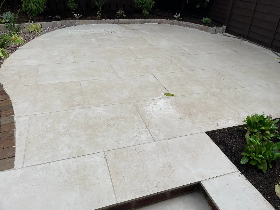 Outdoor porcelain patio tiles before cleaning, showing visible stains and dirt.