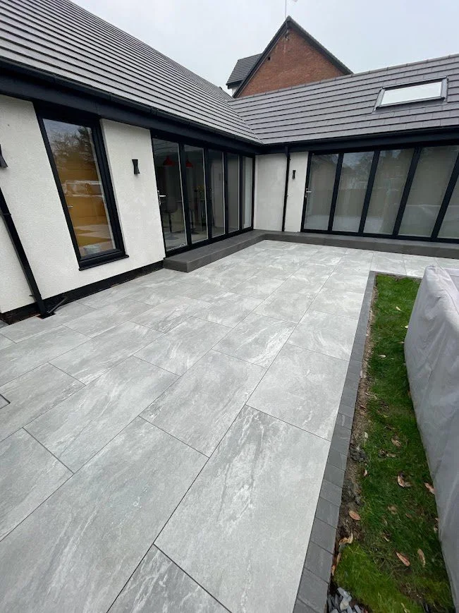 Freshly cleaned outdoor porcelain tiles gleaming on a modern patio after treatment with HR Total Power Clean.