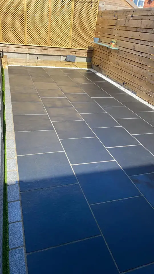 Shimmering black limestone patio after sealing with HR Colour Enhancer to bring out the colour back to black.