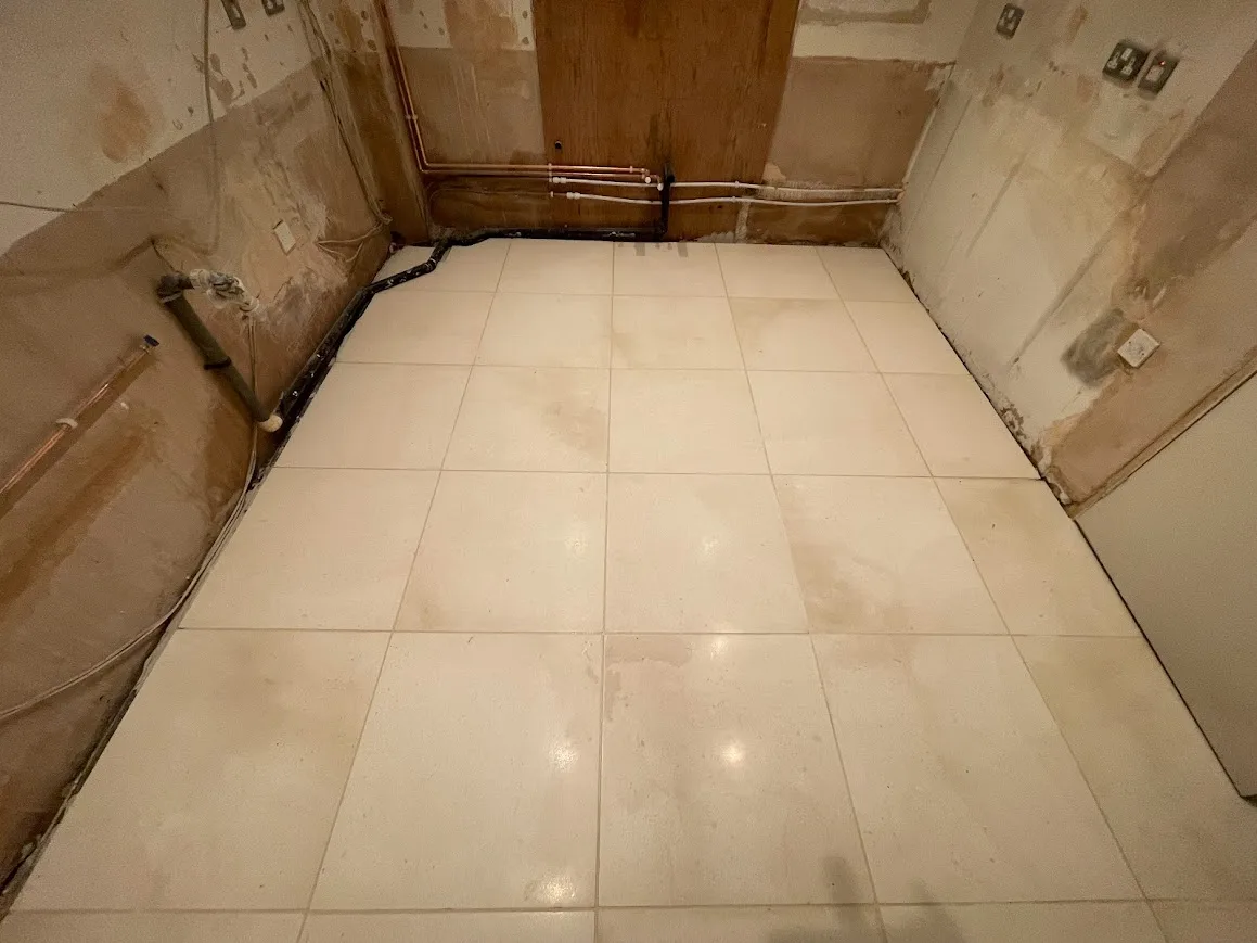After Image of a limestone stone floor tiling being completed and fitted on a concrete floor.