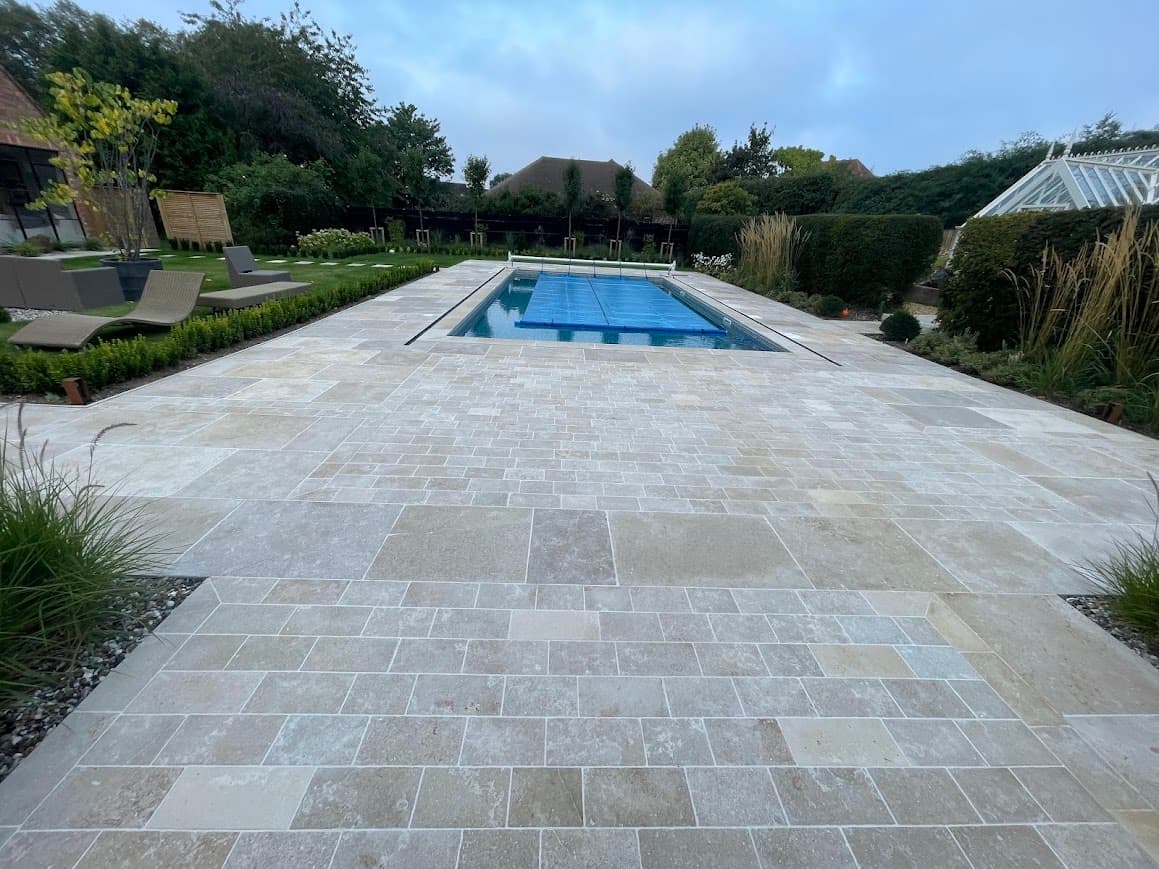 Limestone floor around an indoor pool requiring compatible cleaning and protection