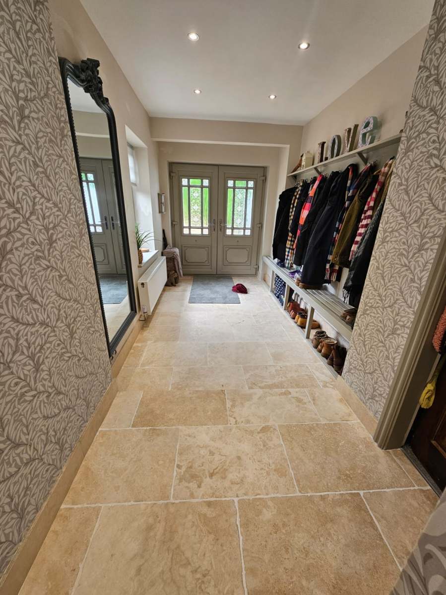 Restored travertine hallway floor after professional treatment