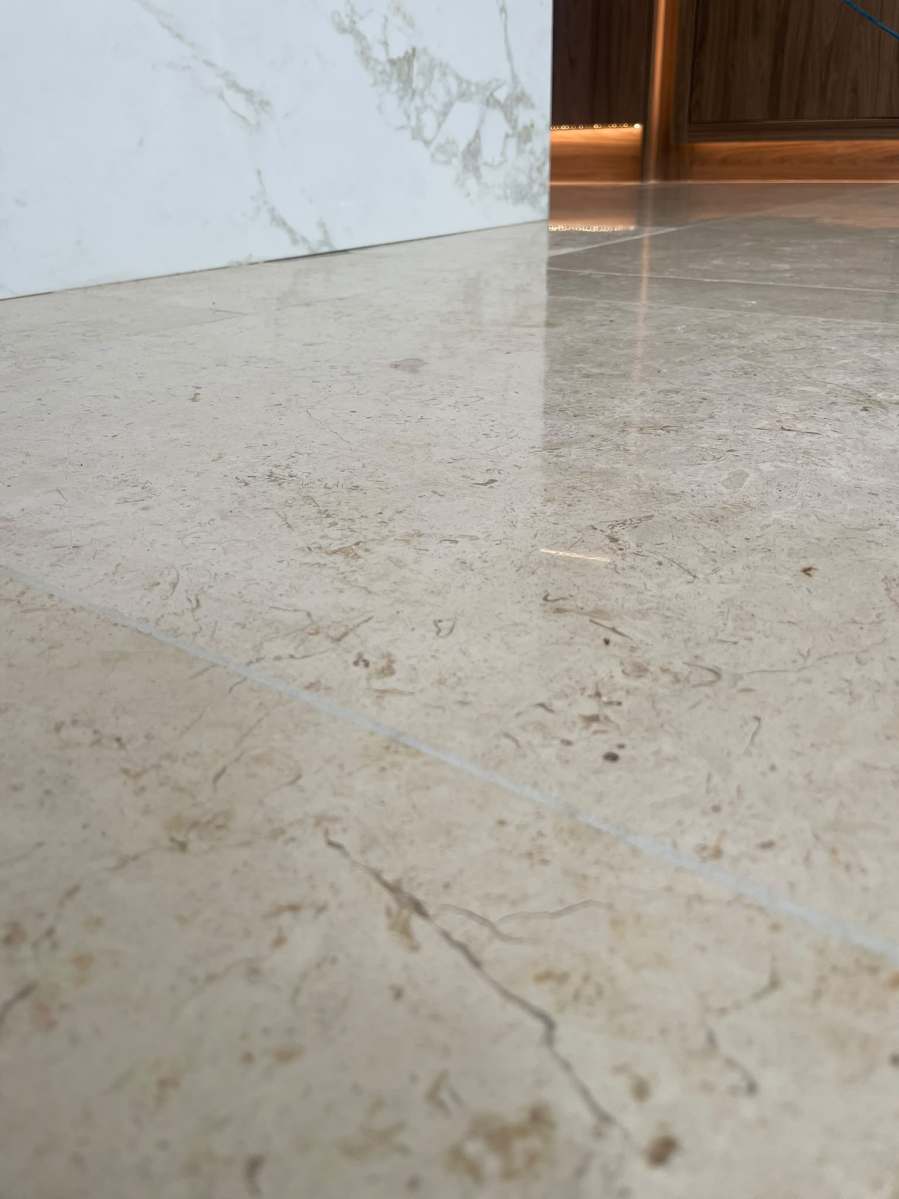 Professional repair to a damaged marble floor tile