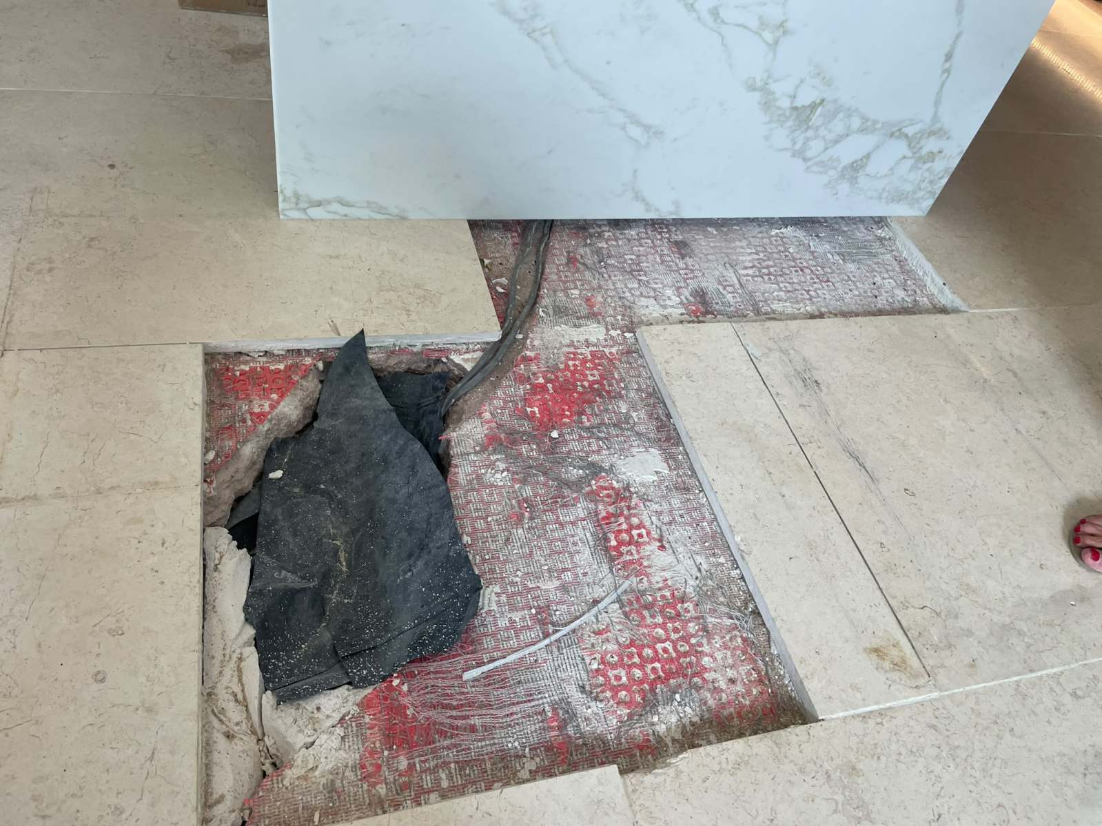 Damaged marble floor tile before professional repair