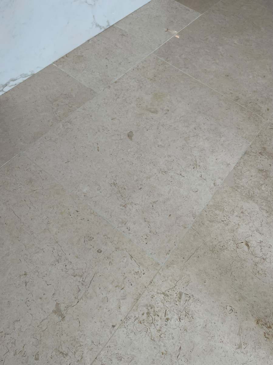 Marble floor tile after professional chip repair and colour matching